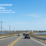 Scenic late-April road approach in the Long Beach Island region, with light traffic, marshland, bay water, and blue sky, illustrating a buyer’s spring test-drive before summer traffic.