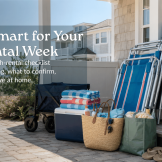 Practical LBI rental packing list with beach chairs, towels, cooler, tote bags, and vacation essentials outside a shore rental home