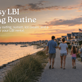 Family walking along a bayside path on Long Beach Island at sunset with ice cream and coastal homes in the background