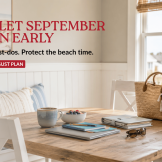 Late-August LBI vacation rental dining area with beach gear, school supplies, laptop and planner ready for back-to-school prep.