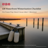 Frosty lagoon bulkhead with winter lines, fenders, and light ice—LBI waterfront winterization.