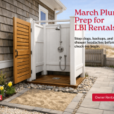 Outdoor shower beside a Long Beach Island vacation rental home in early spring, showing plumbing prep, drainage, and sand-control features before summer guests arrive.