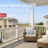 Porch and upper deck of a Long Beach Island summer rental with coastal seating, flowers, and bright vacation-season light