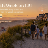 July 4th week on LBI with vacation renters walking to the beach at sunset as fireworks light up the shore.