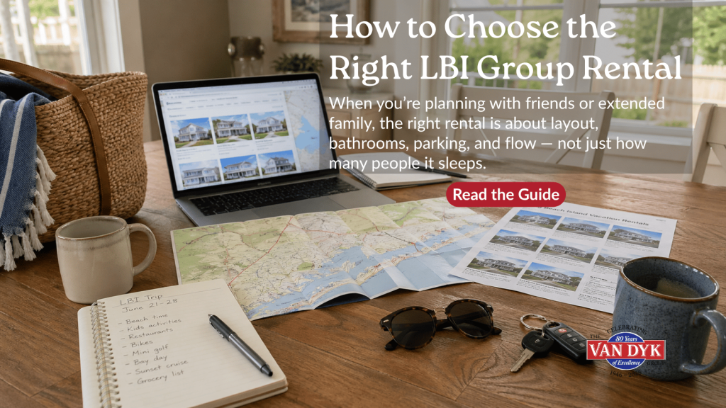 Planning an LBI group rental trip with maps, laptop, rental listings, and travel notes on a dining table.