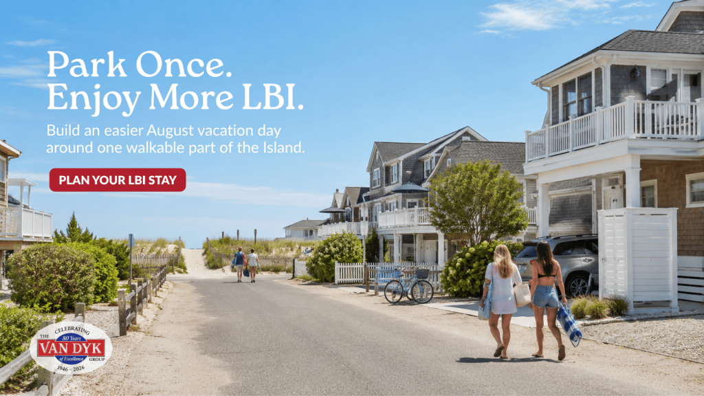 Long Beach Island vacationers walking toward an ocean beach access with bikes, coastal homes, and light beach gear on a sunny August day.